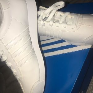 All white Adidas samoas